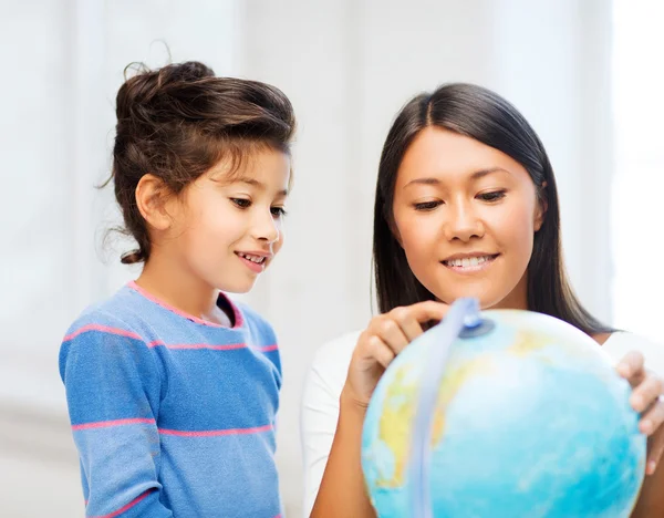 Mor och dotter med globe — Stockfoto