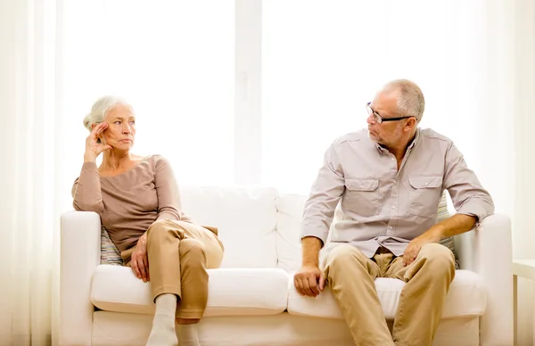 Senior couple sitting on sofa at home — Stock Photo, Image