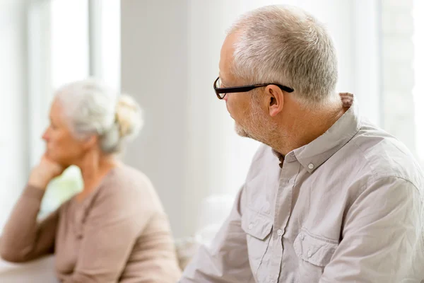 Senior couple sitting on sofa at home — Stock Photo, Image