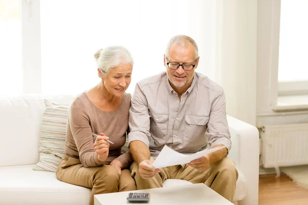 Senior couple with papers and calculator at home — Stock Photo, Image