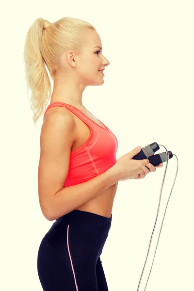 Smiling sporty woman with with skipping rope — Stock Photo, Image