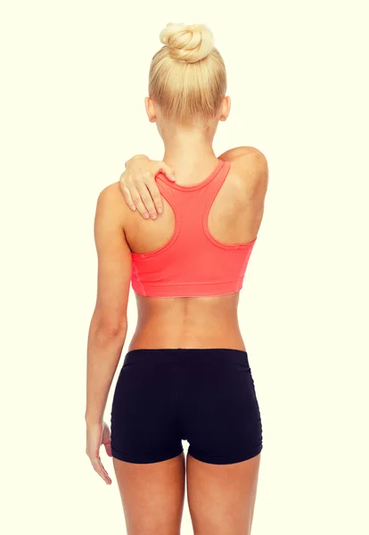 Sporty woman touching her shoulder — Stock Photo, Image