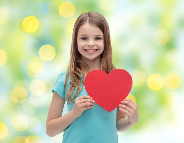 Smiling little girl with red heart — Stock Photo, Image