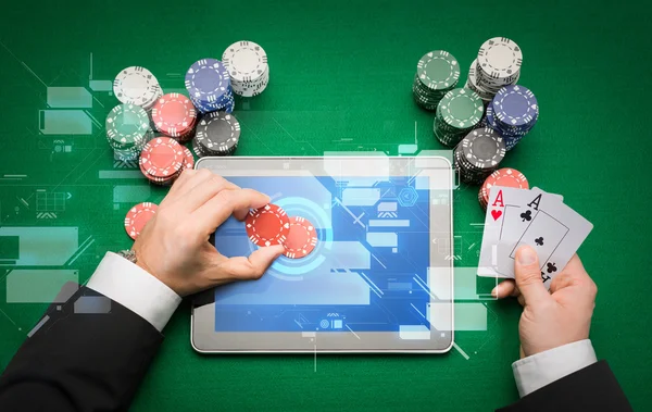 Casino poker player with cards, tablet and chips — Stock Photo, Image