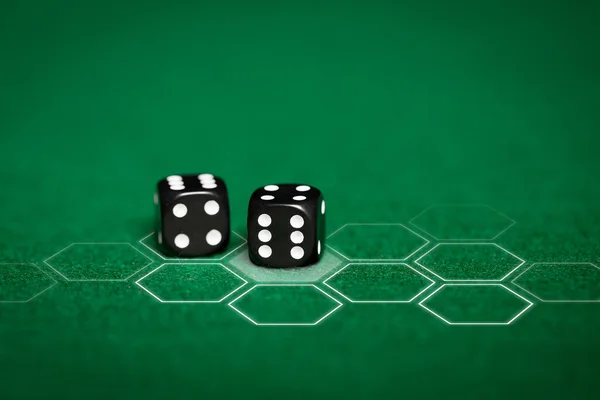 Close up of black dice on green casino table — Stock Photo, Image