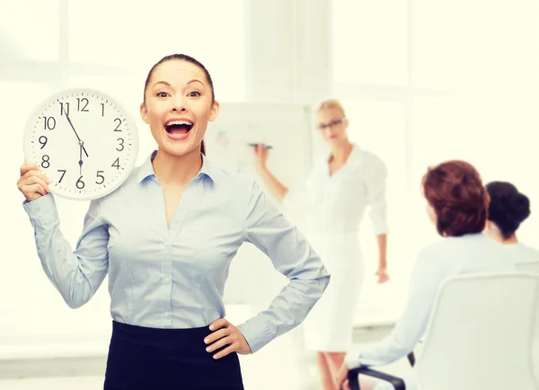 Atractiva mujer de negocios con reloj de pared — Foto de Stock