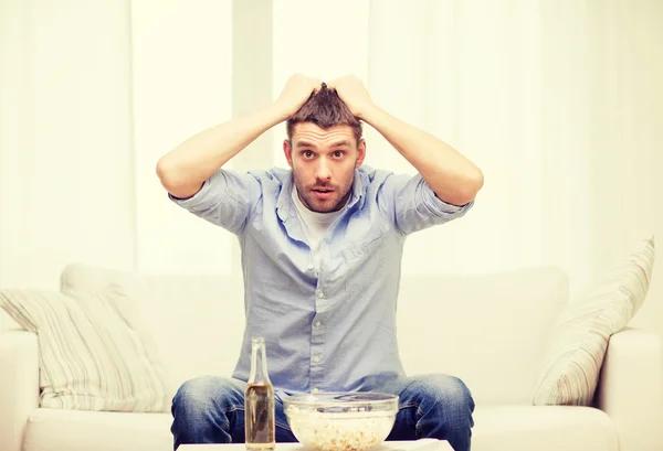 Sad man watching sports at home — Stock Photo, Image