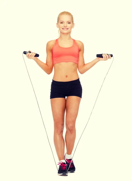 Smiling sporty woman with with skipping rope — Stock Photo, Image