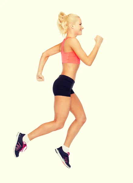 Sporty woman running or jumping — Stock Photo, Image