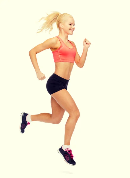 Sporty woman running or jumping — Stock Photo, Image