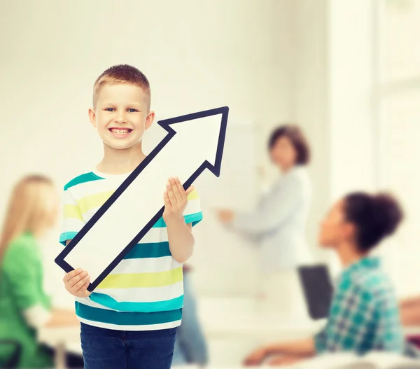 Smiling little boy with blank arrow pointing right — Stock Photo, Image