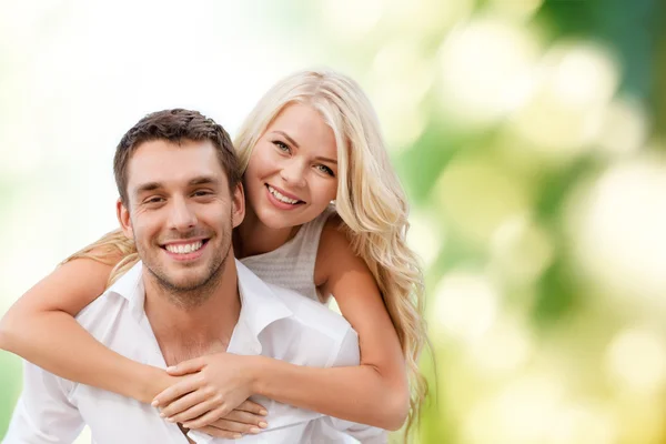 Happy couple having fun over green background — Stock Photo, Image