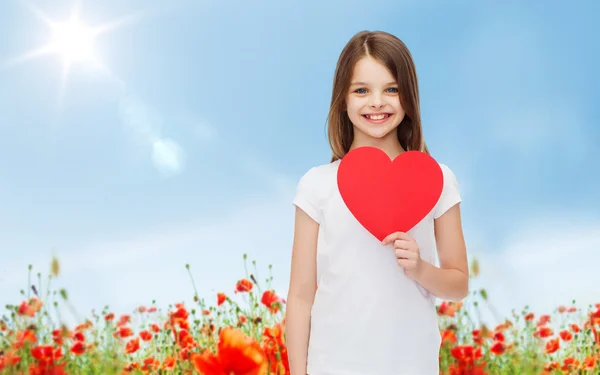 Smiling little girl with red heart — Stock Photo, Image