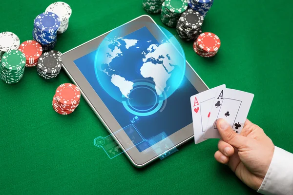 Casino poker player with cards, tablet and chips — Stock Photo, Image