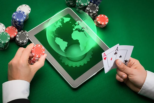 Joueur de poker casino avec cartes, tablette et jetons — Photo