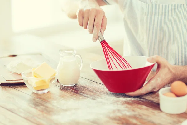 Close up of male hand whisking something in a bowl — Stock Photo, Image