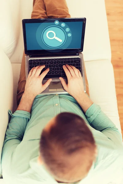 Close up of man working with laptop at home — Stock Photo, Image