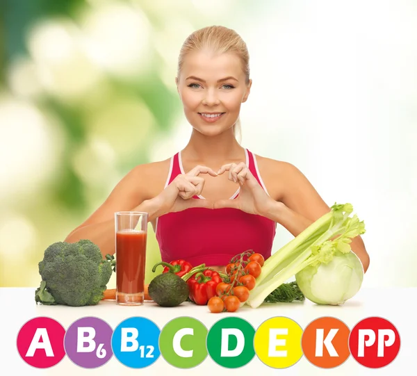 Happy woman with organic food and vitamins — Stock Photo, Image