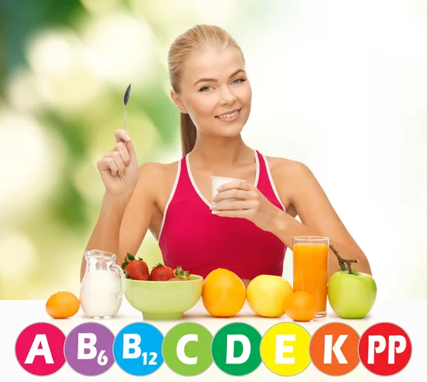 Happy woman with organic food and vitamins — Stock Photo, Image
