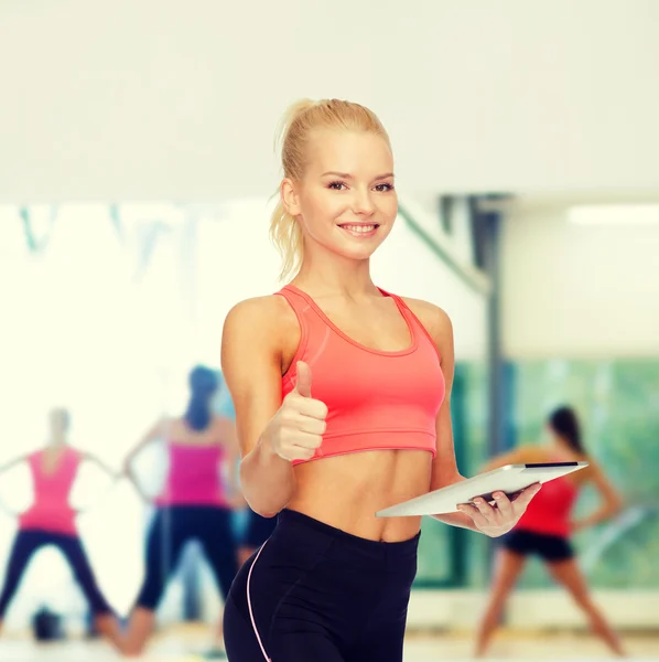 Smiling sporty woman with tablet pc computer — Stock Photo, Image