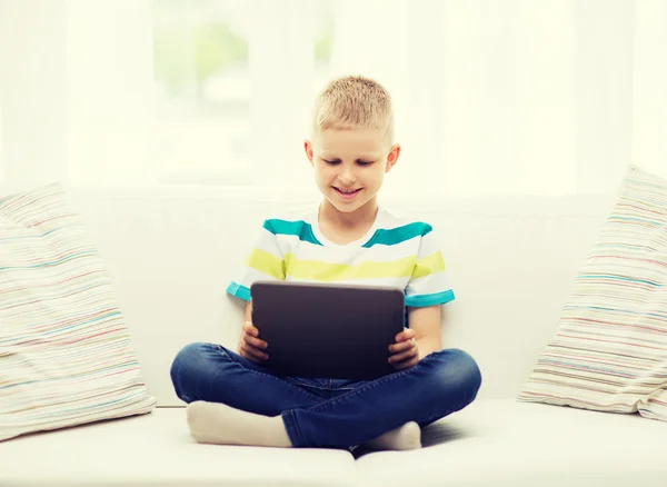 Lachende jongen met tablet pc thuis — Stockfoto