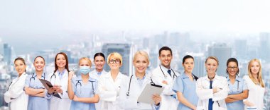 smiling female doctors and nurses with tablet pc clipart