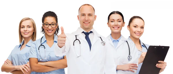 Group of smiling doctors with showing thumbs up — Stock Photo, Image