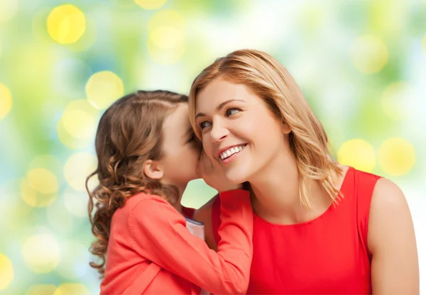 Happy daughter whispering gossip to her mother — Stock Photo, Image