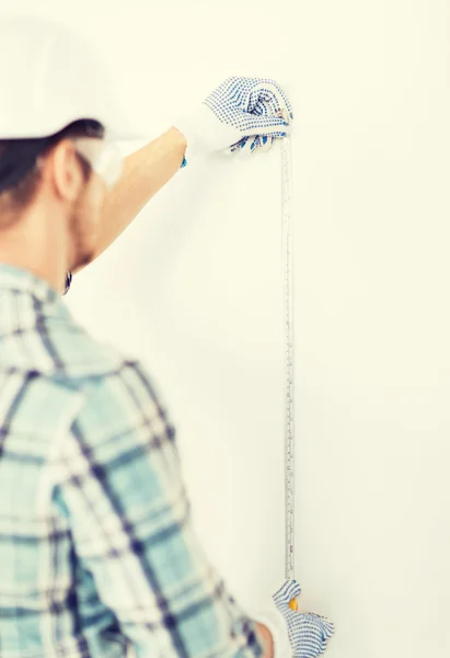 Architect measuring wall with flexible ruler — Stock Photo, Image