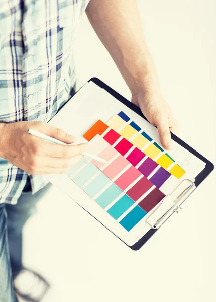 Man with color samples for selection — Stock Photo, Image