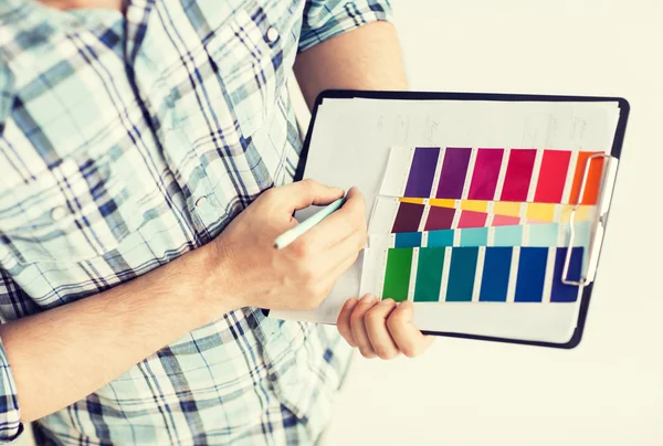 Man with color samples for selection — Stock Photo, Image