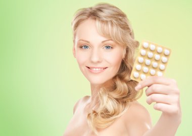 happy young woman holding package of pills clipart
