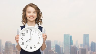 smiling girl holding big clock clipart