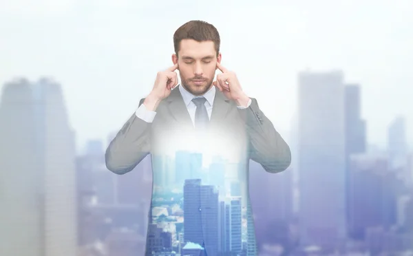 Annoyed businessman covering ears with his hands — Stock Photo, Image