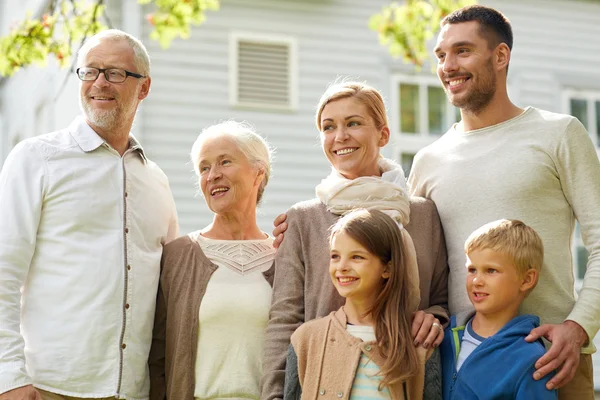 Familia feliz en frente de la casa al aire libre —  Fotos de Stock