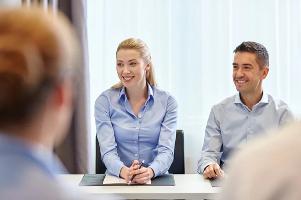 Grupo de empresários sorridentes reunidos no escritório — Fotografia de Stock