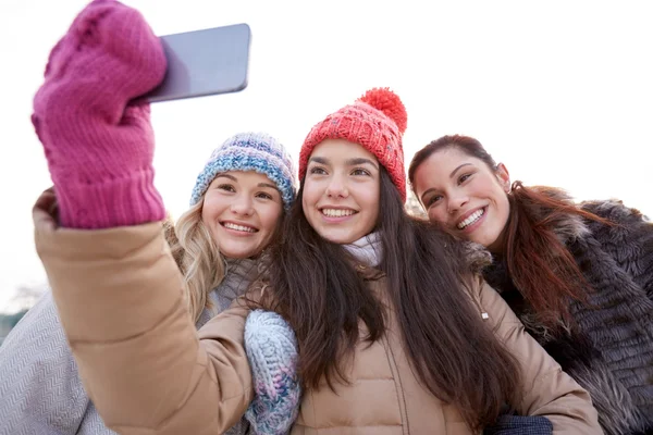 Happy teenage girls taking selfie with smartphone — Stock Photo, Image