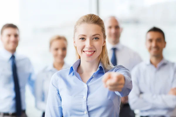 Smiling businesswoman pointing finger on you — Stock Photo, Image