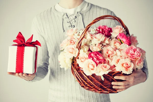 Adamı sepeti çiçek ve hediye kutusu dolu holding — Stok fotoğraf