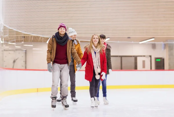 Happy friends on skating rink — Stock Photo, Image