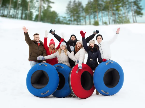 Groep lachende vrienden met sneeuw buizen — Stockfoto