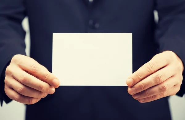 Man in suit holding blank card — Stock Photo, Image