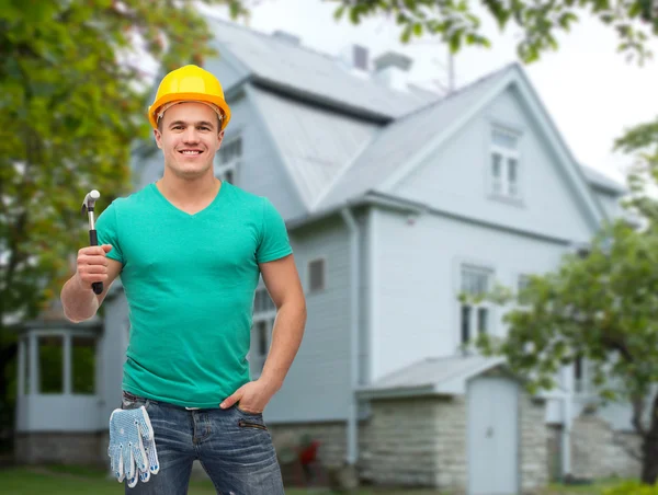 Operaio manuale sorridente in casco con martello — Foto Stock