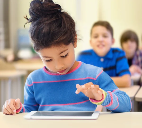 Little school girl with tablet pc over classroom — Stock Photo, Image