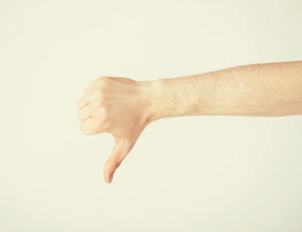Man showing thumbs down — Stock Photo, Image