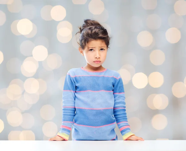Sad little girl over city background — Stock Photo, Image