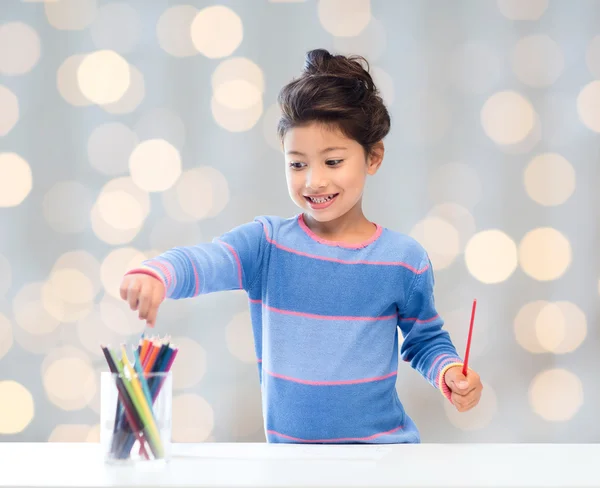 Happy little girl drawing with coloring pencils — Stock Photo, Image