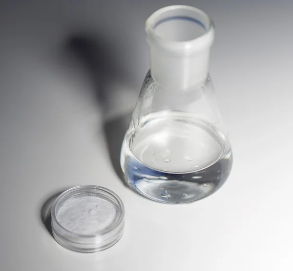 Close up of flask with water or liquid chemical — Stock Photo, Image