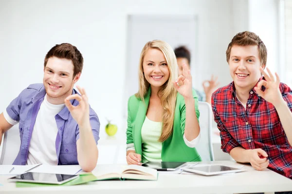 Students with tablet pcs showing ok sign — Stock Photo, Image