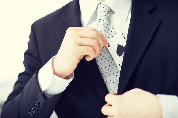 Mans hand hiding ace in the jacket pocket — Stock Photo, Image